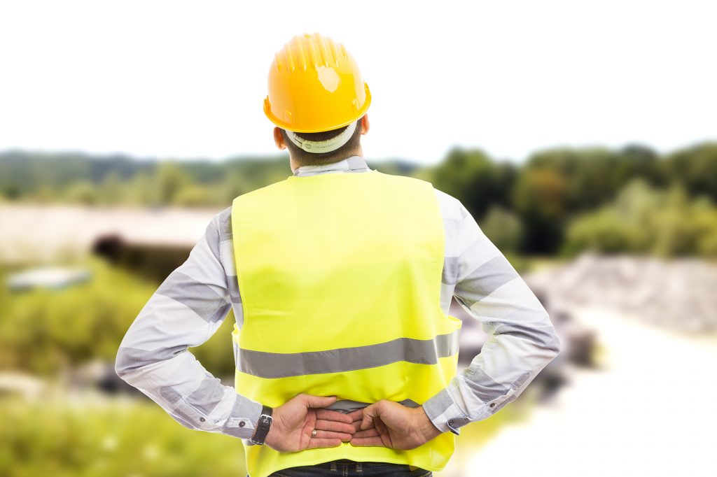 Injured construction worker accident claims Wakefield - suffering backpain in lower back area outdoor at work